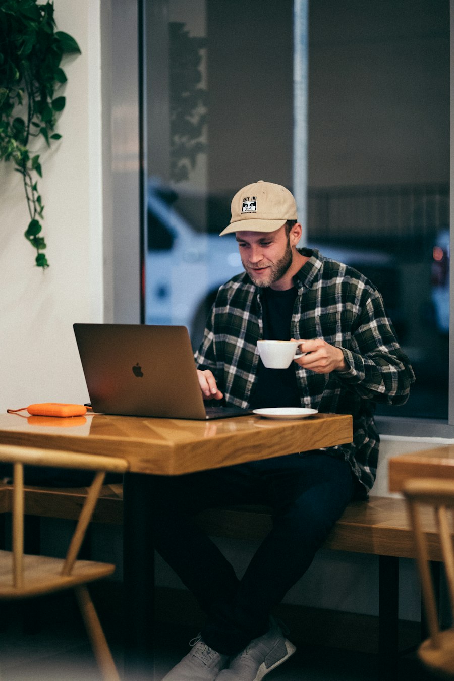 Founder working on a laptop with a coffee